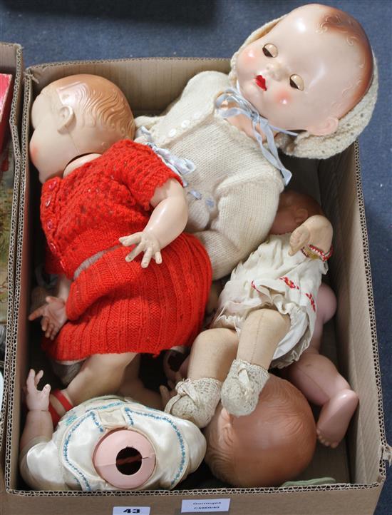 Four plastic and composition dolls
